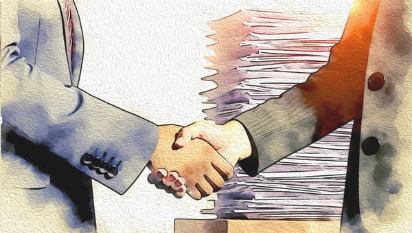 Handshake in a business setting with a background of stacked contracts, highlighting the importance of volume for negotiating strength in insurance.